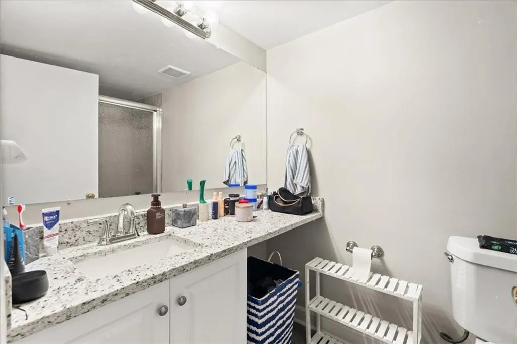 Full bathroom with vanity and a stall shower