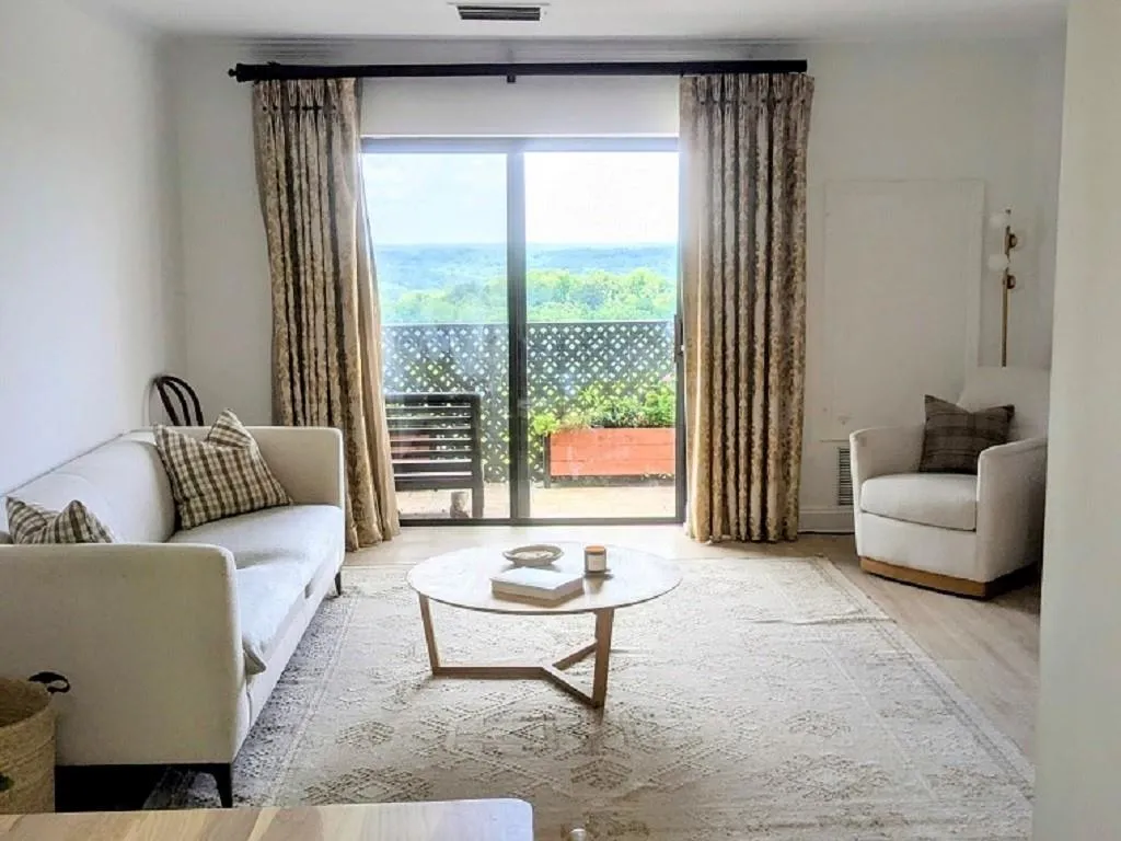 Living room with hardwood / wood-style flooring and a healthy amount of sunlight