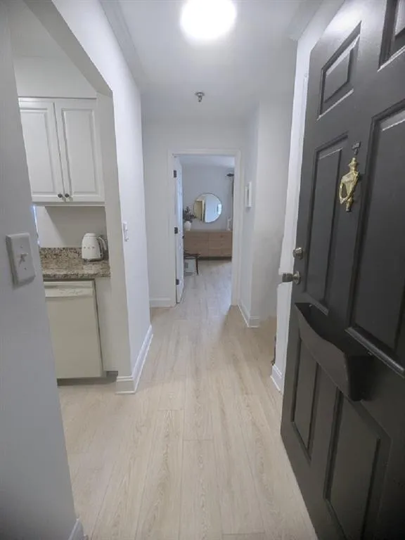 Corridor with light wood-type flooring