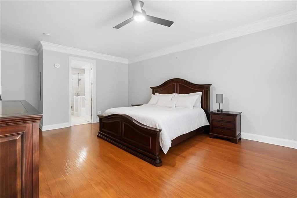 The primary bedroom is on the left side of the home with a custom designed closet in the background.