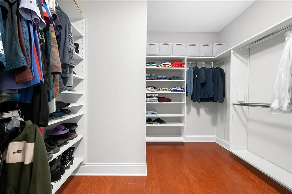 Spacious, custom-designed closet with built in shelves and plenty of hanging space to keep everything organized and easily accessible.