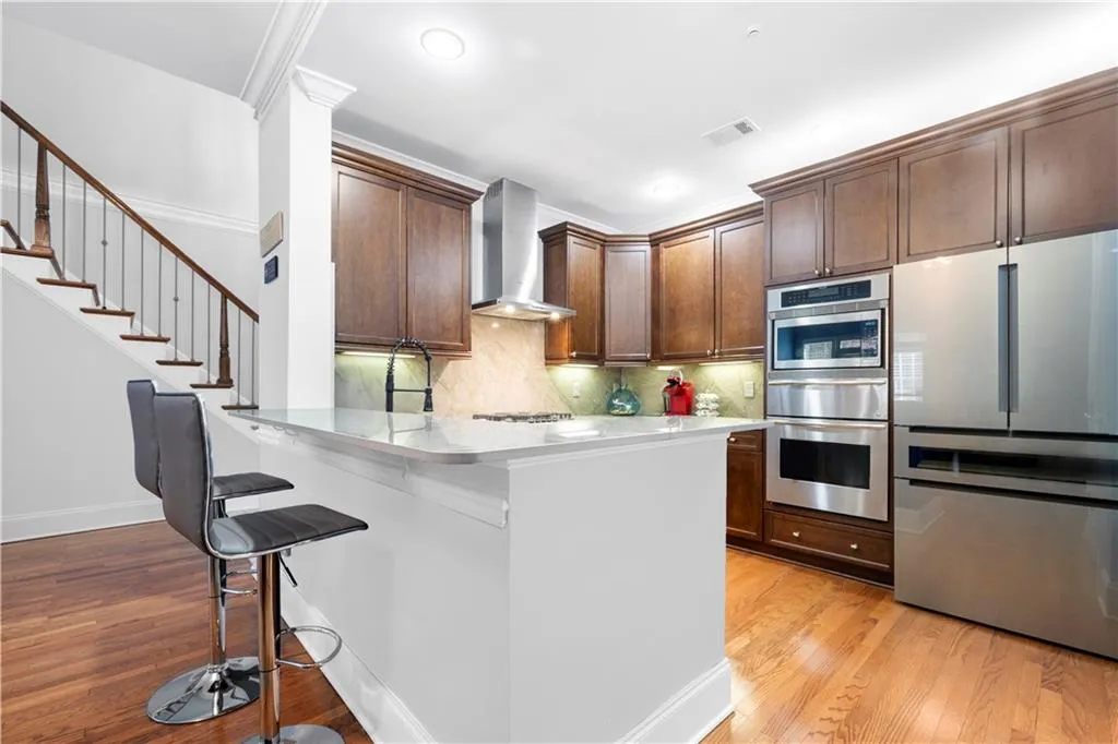 Chef's kitchen featuring a sleek new Dekton countertop and breakfast bar perfect for casual dining or entertaining.