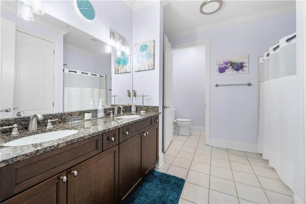 Ensuite bathroom featuring double vanities and perfect for your guest's relaxation.