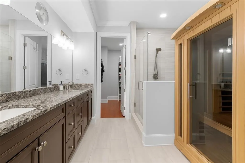 Step into the newly renovated primary bath - a spa-inspired retreat with a glass shower, built-in bench, private water closet, and in-unit sauna. Designed for peace, comfort, and everyday luxury.