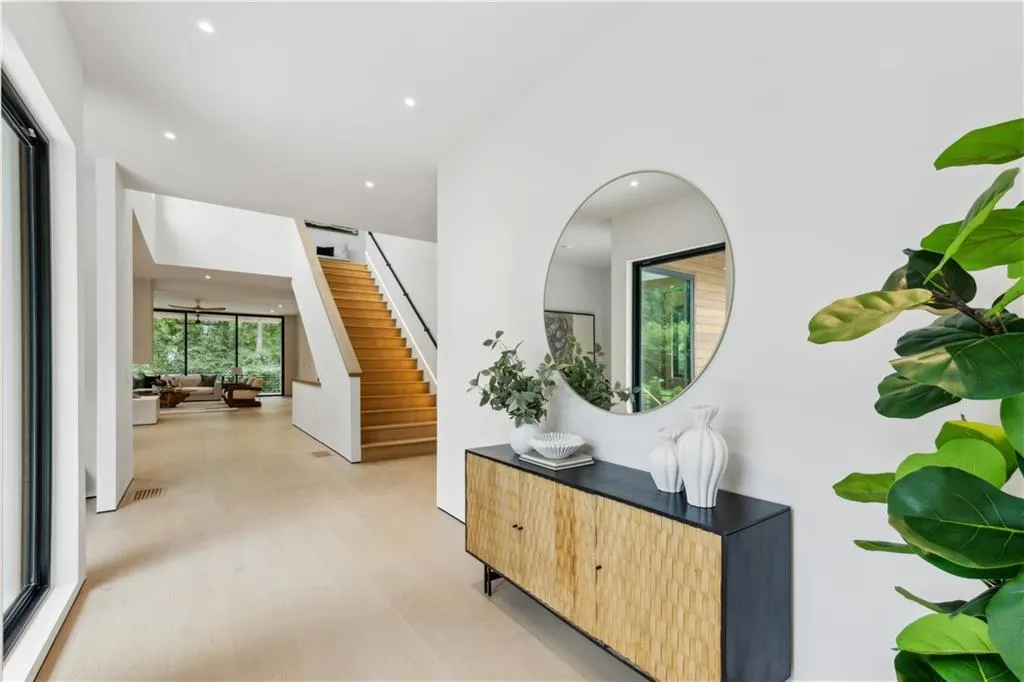 Hallway with stairs, light wood-style flooring, and recessed lighting