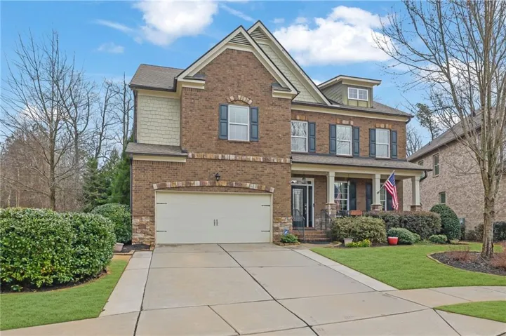 Elegant two-story brick Colonial with a professionally paved driveway and integrated two-car garage
