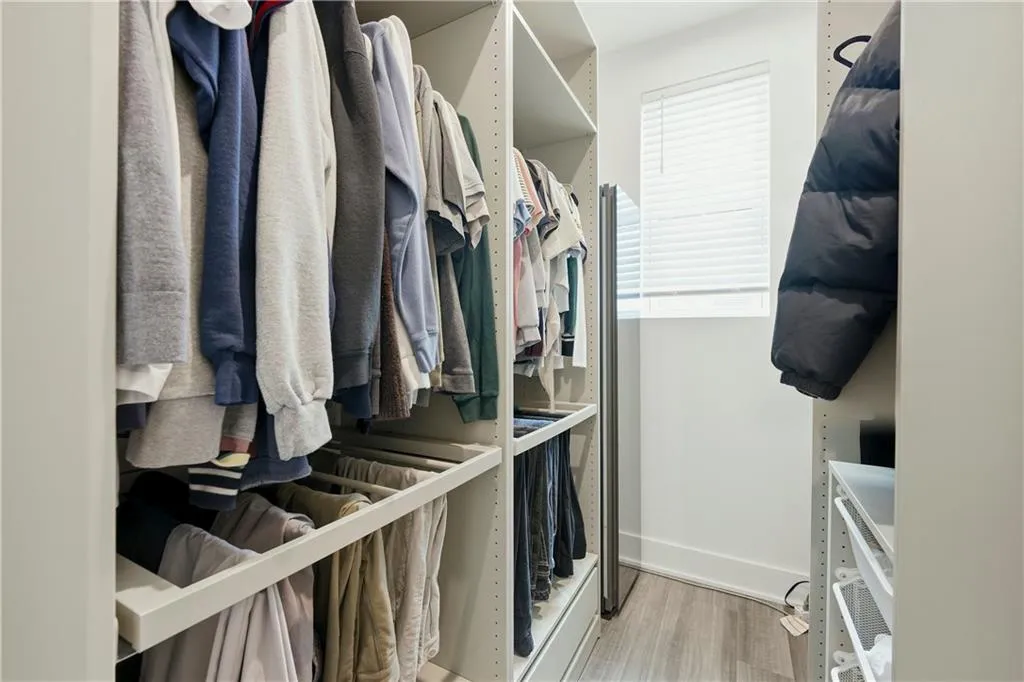 Built-in closet system with adjustable shelving, integrated hanging rods, and pull-out drawers