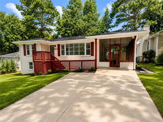 Ranch-style residence featuring a red-painted front deck, white exterior, and a screened porch with a ceiling fan