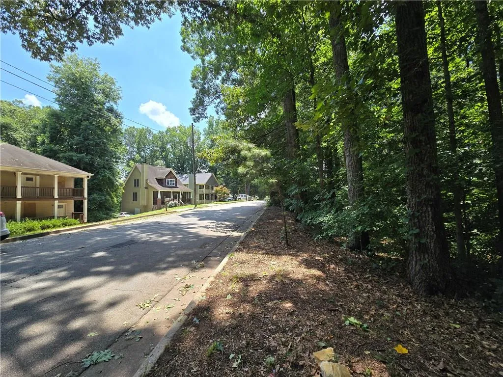View of asphalt street featuring curbs