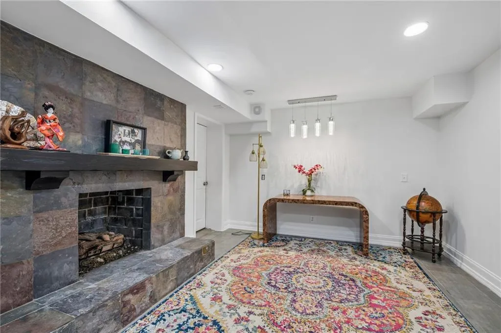 Stone-clad fireplace with a dark wood mantel and hearth