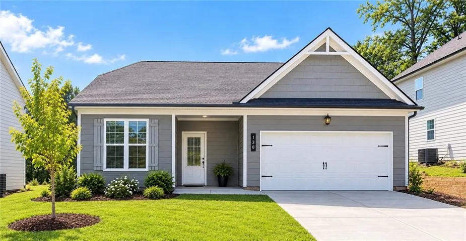 Craftsman-style exterior with gray siding, a prominent gable, and a covered entry