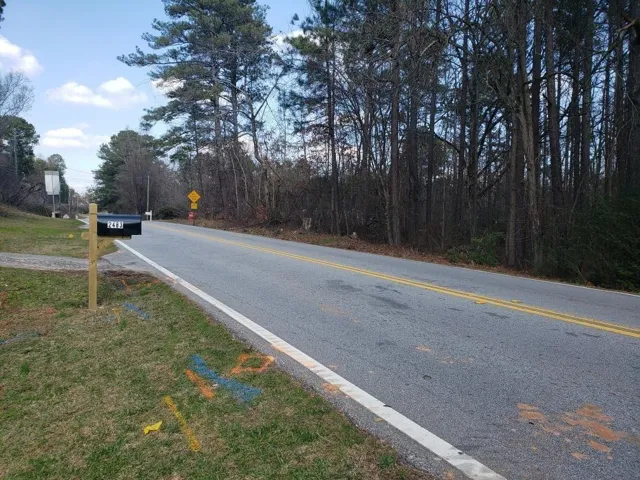 View of asphalt street with traffic signs