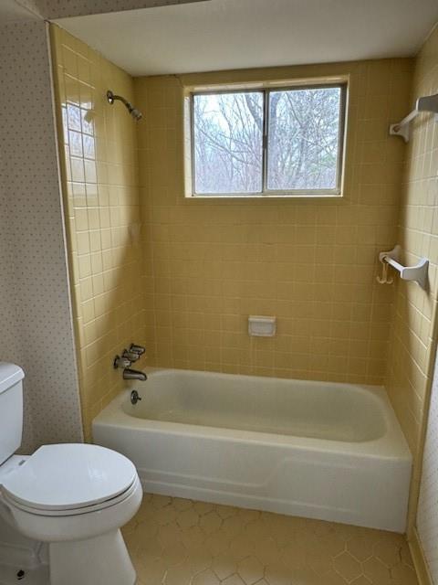 Primary Bath featuring toilet, tile flooring, and vintage tiled shower / bath