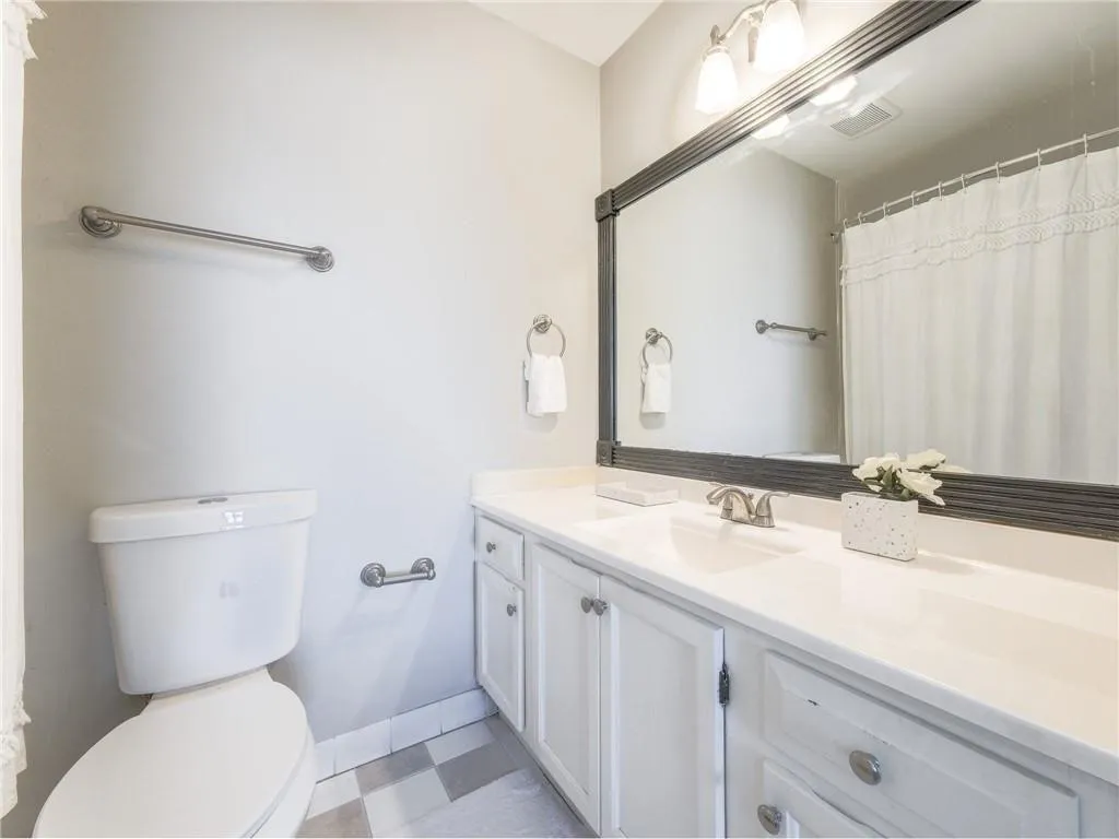 Bathroom with a shower with curtain and vanity