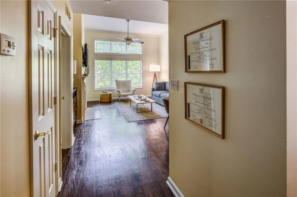 Hall featuring dark wood finished floors and crown molding