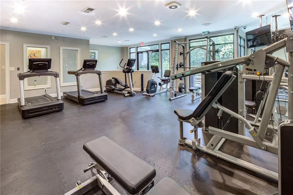 Workout area with recessed lighting and crown molding