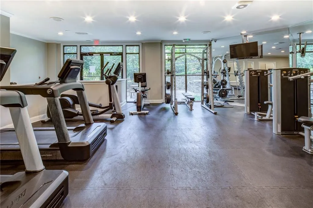 Workout area with recessed lighting and ornamental molding