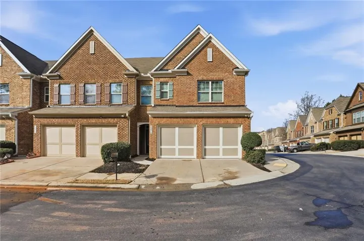 Brick exterior with gabled roof lines, two-car garage, and shuttered windows