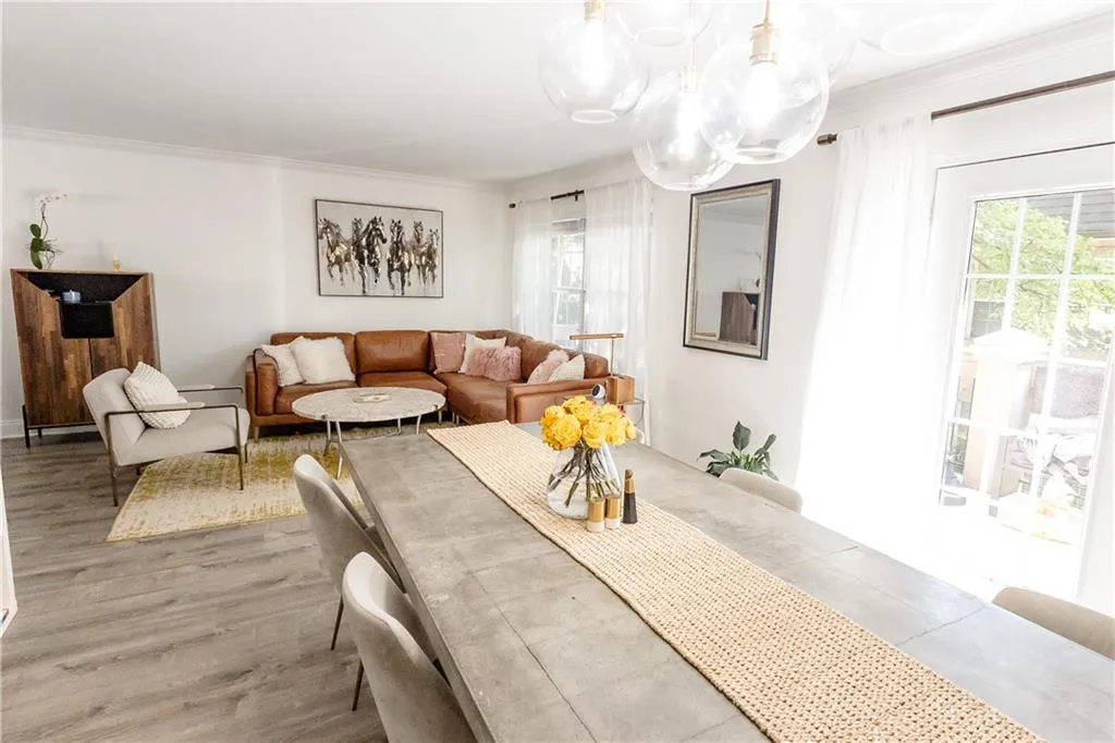 Dining area featuring ornamental molding, a wealth of natural light, and hardwood / wood-style floors