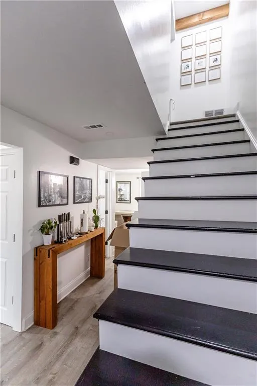 Stairway featuring wood-type flooring