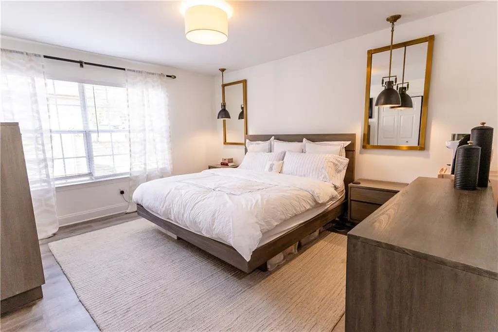 Bedroom with light hardwood / wood-style flooring
