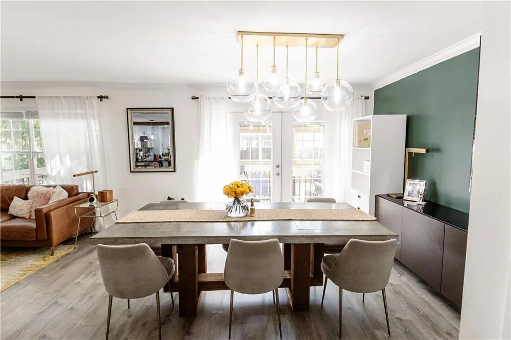 Dining space featuring ornamental molding and wood-type flooring
