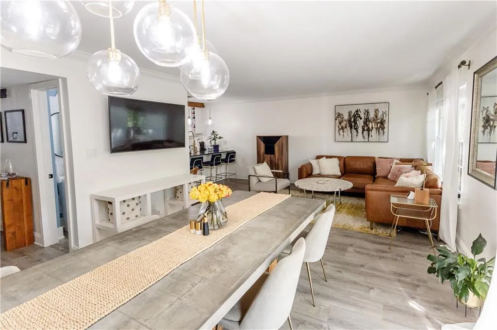 Living room featuring crown molding and light hardwood / wood-style flooring