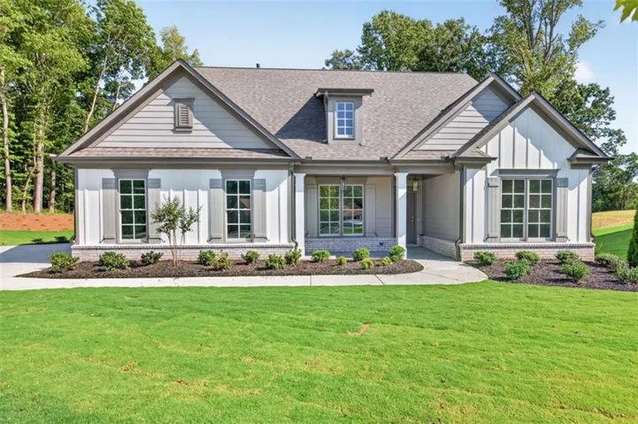Siding exterior with board and batten accents, a dormer window, and a covered entry