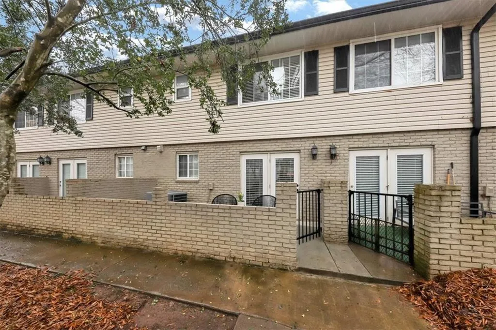 Rear view of property featuring french doors and central AC