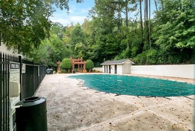 View of swimming pool with a patio area and an outdoor structure