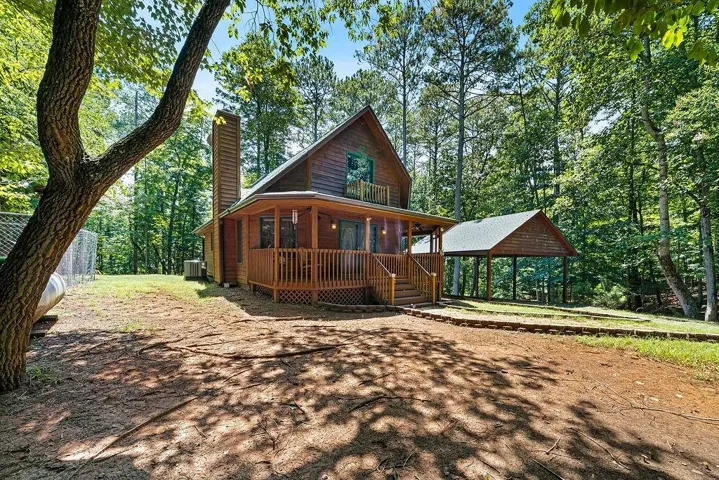 Wood-sided home with a covered front porch and second-story balcony