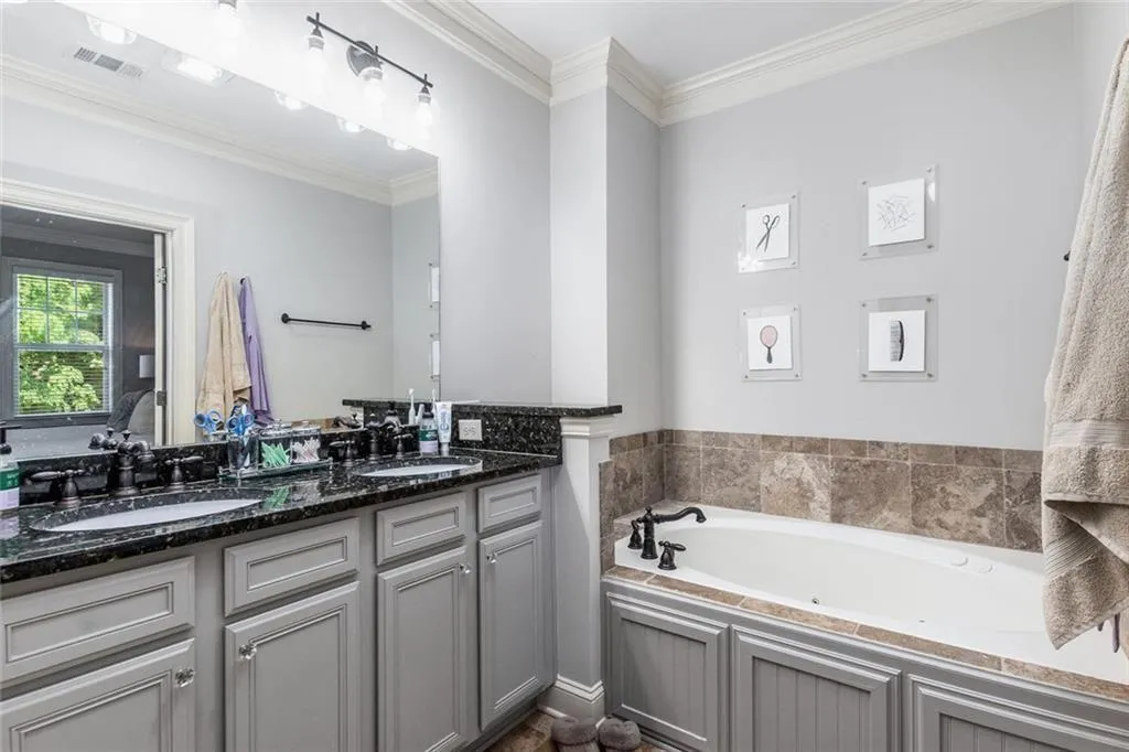 The primary en suite has double vanities, large separate soaking tub, and glass door shower.