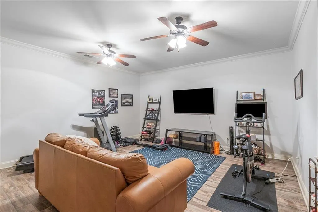 The fully finished terrace level features a large den with wood-look tile floors, an additional half bath, and access to the two-car garage.