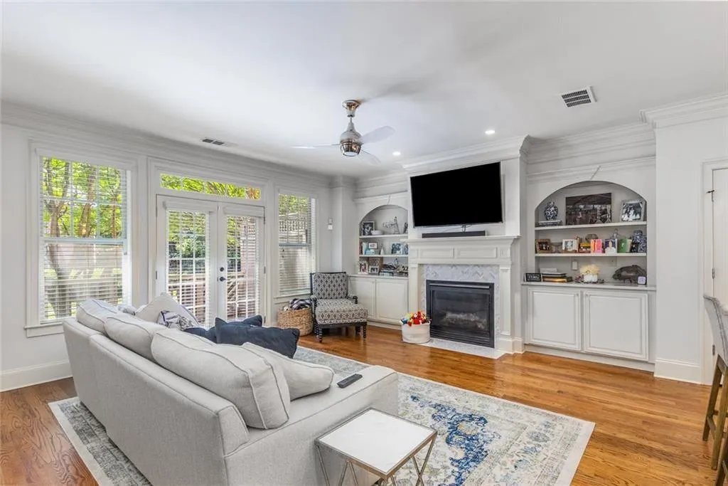 The large living room features a gas fireplace with custom surround, plus built-ins with quartz countertops for tons of storage.