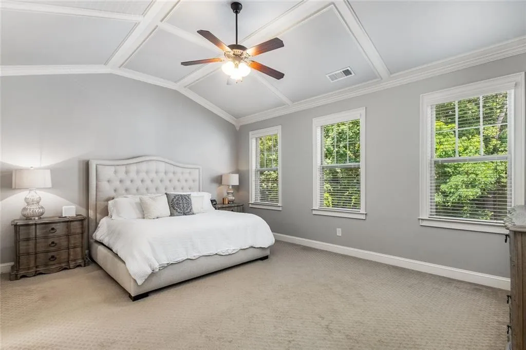 Upstairs, the oversized primary suite features a vaulted ceiling and tons of natural light.