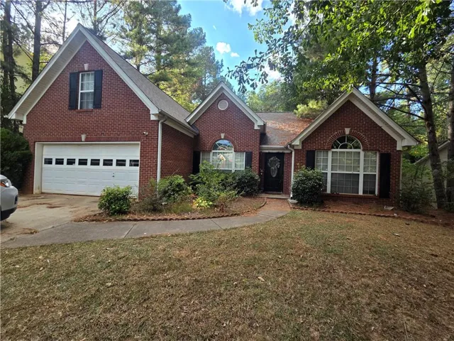 Brick exterior with a gabled roof and arched window accents