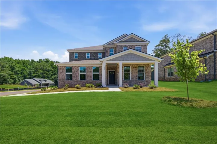 Two-story brick exterior with a welcoming covered front porch