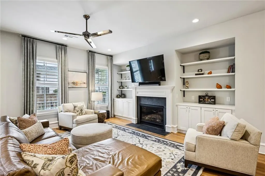 Living area featuring wood-finish flooring, recessed lighting, and a modern ceiling fan