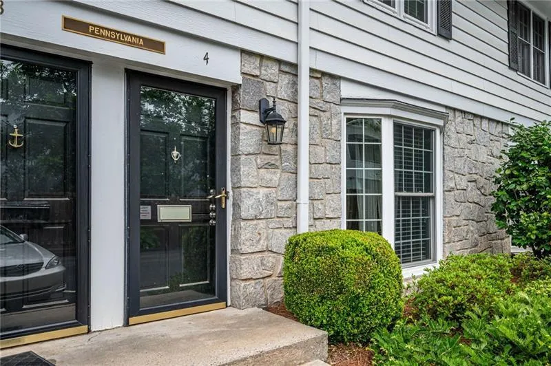 Entrance to property with stone siding