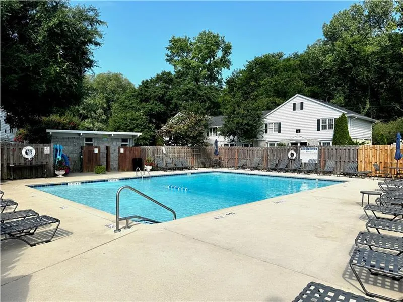 Community pool with a patio