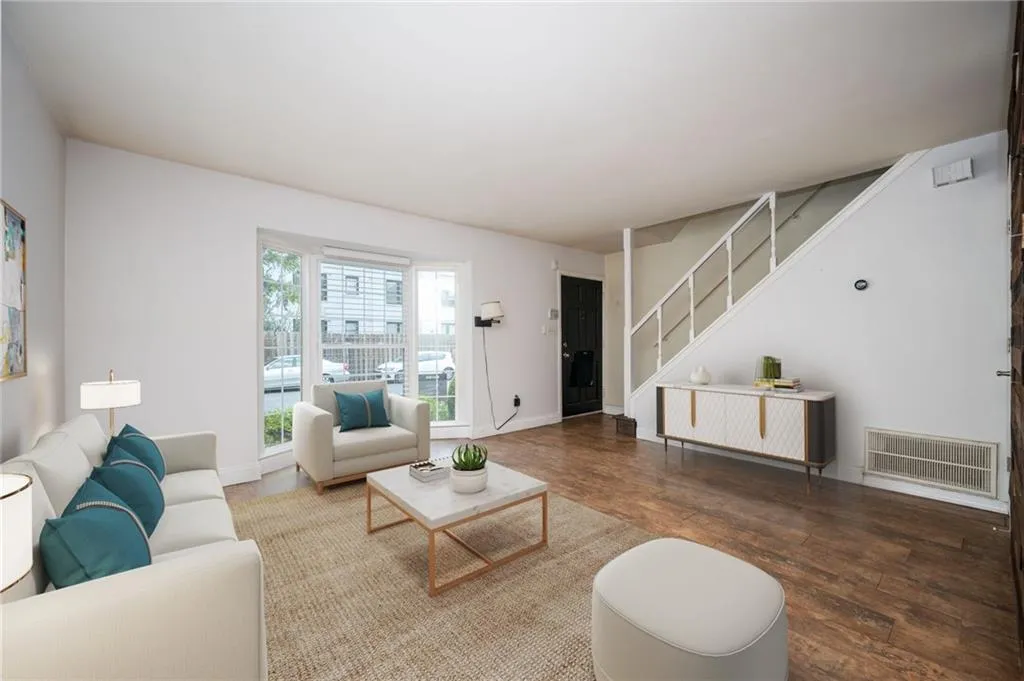 Living area with wood finished floors and stairs