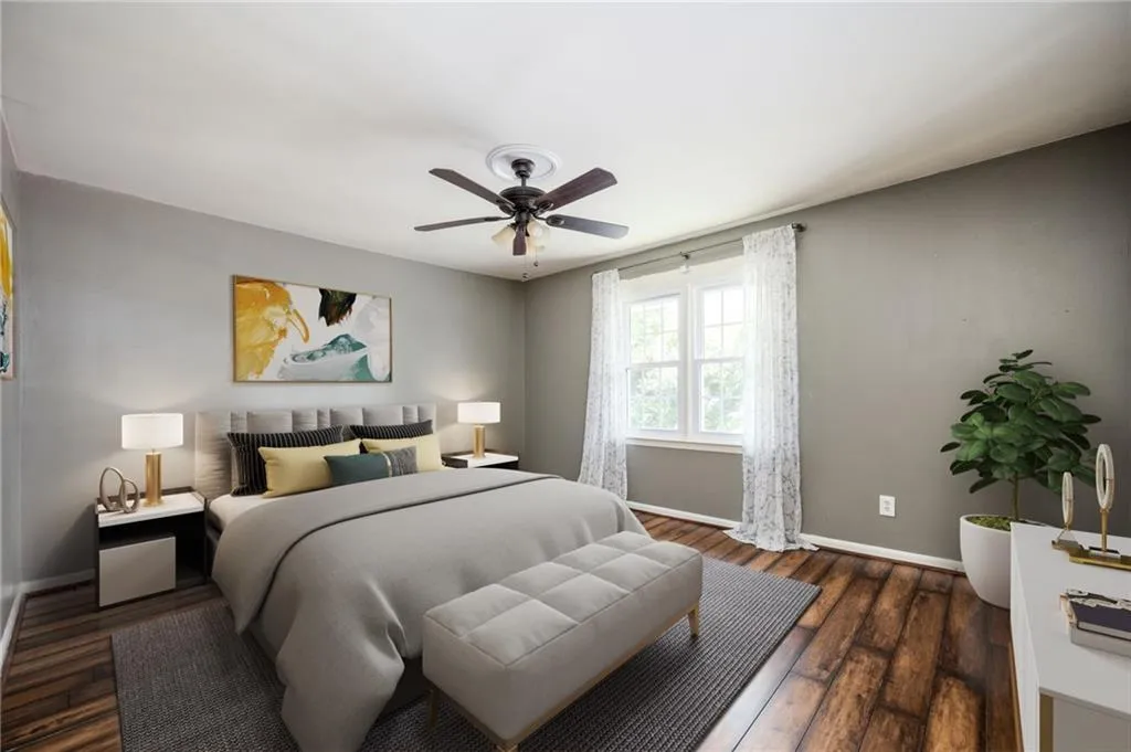 Bedroom featuring wood finished floors and a ceiling fan