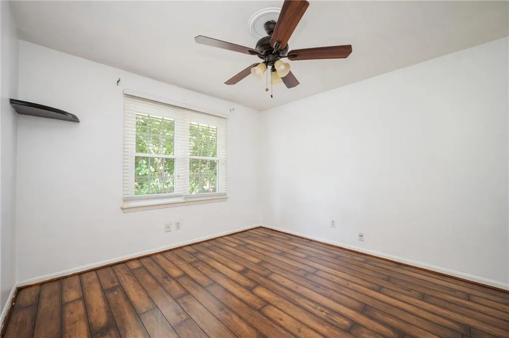 Spare room featuring hardwood / wood-style floors and a ceiling fan