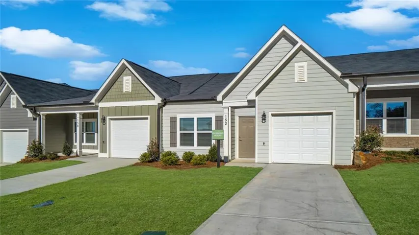 View of front of property with a garage and a front yard