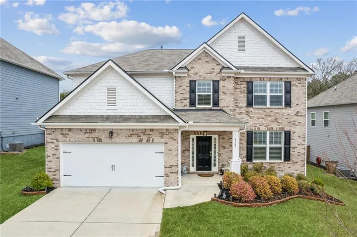 Brick and siding exterior with a two-car garage
