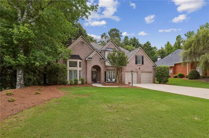 Welcome Home to 6930 Olde Atlanta Parkway! 4 Bedrooms 3 1/2 bath PLUS Home Office on Main! 3 sides BRICK