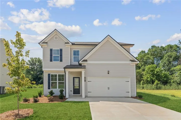 Two-story residence featuring light gray siding, dark shutters, and a covered entryway