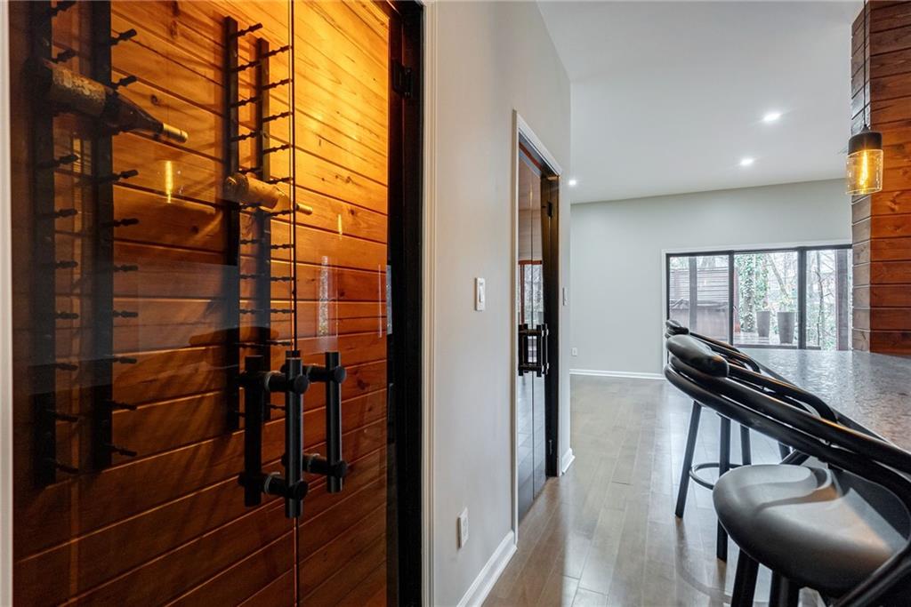 Hall with dark hardwood / wood-style flooring and wood walls