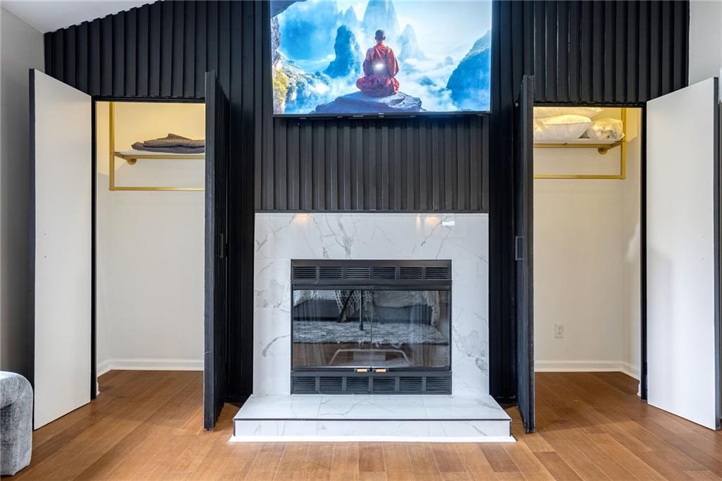 Room details featuring a premium fireplace and wood-type flooring