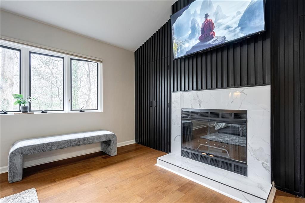Living room with a fireplace and light hardwood / wood-style floors